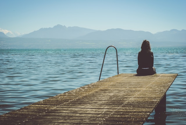 paola-chaaya-eAkjzXCU0p0-unsplash woman looking out on to lake